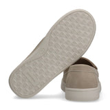 Beige low-cut sneaker with a suede-like upper and thick beige sole. The sole features an embossed "CK" logo pattern and "Calv