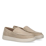 Pair of beige Calvin Klein Kids low cut slip-on sneakers with moccasin-style stitching and a thick white sole.
