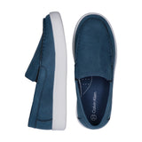 Pair of blue low-cut slip-on sneakers with white soles. Features moccasin-style stitching and a subtle CK logo.