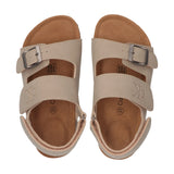 Pair of beige sandals with two wide straps, silver-toned buckles, and velcro back straps. Features a tan genuine leather inso