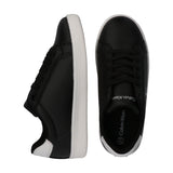 Black low-cut lace-up sneakers with white soles. The left shoe has a white heel accent. The right shoe shows 'Calvin Klein' o
