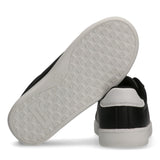Black low-cut sneakers with white soles. One sole has a 'CK' pattern and 'Calvin Klein' text. The other sneaker has a white h