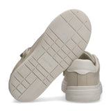 Beige low-cut sneaker with a white heel collar. Features a thick, off-white sole with a grid pattern and "Calvin Klein" brand