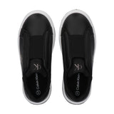Pair of black low-cut slip-on sneakers with white soles. Each has a white 'ck' logo, elastic instep, and 'Calvin Klein 31' on