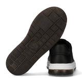 Black low-cut sneaker with a black leather-look upper, white midsole, and dark brown textured outsole with Calvin Klein brand