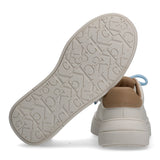 Off-white low-cut sneaker with a tan heel tab, light blue laces, and an off-white sole embossed with 'CK' and 'Calvin Klein'.