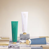Aqua green hand cream tube with white 'Aqua Media' text and a gold-toned cap.