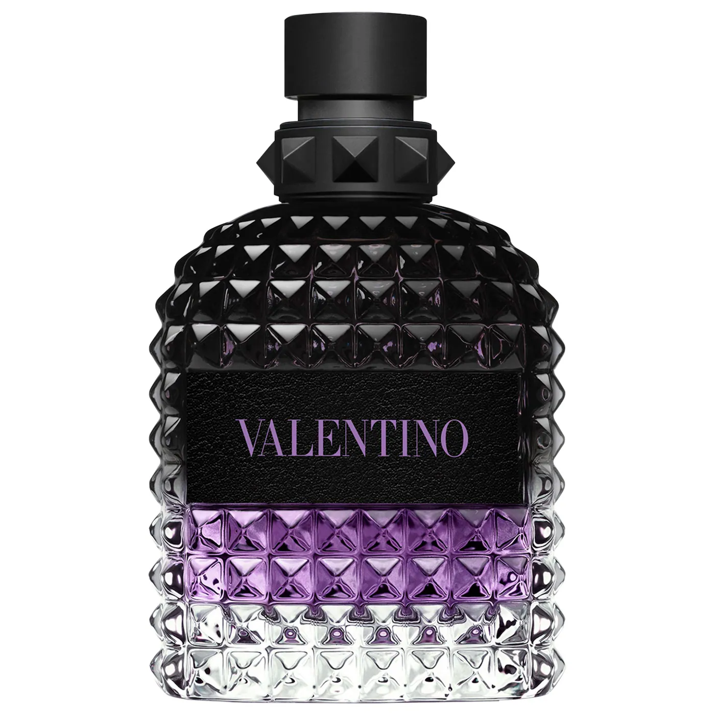 A close-up of a Valentino Uomo Born In Roma Stravaganza fragrance bottle. The glass features the signature rockstud pyramid texture with a gradient transitioning from clear at the base to a vibrant purple in the middle and a deep, translucent black at the top. It is finished with a matte black cap and a black leather-style label with purple branding.