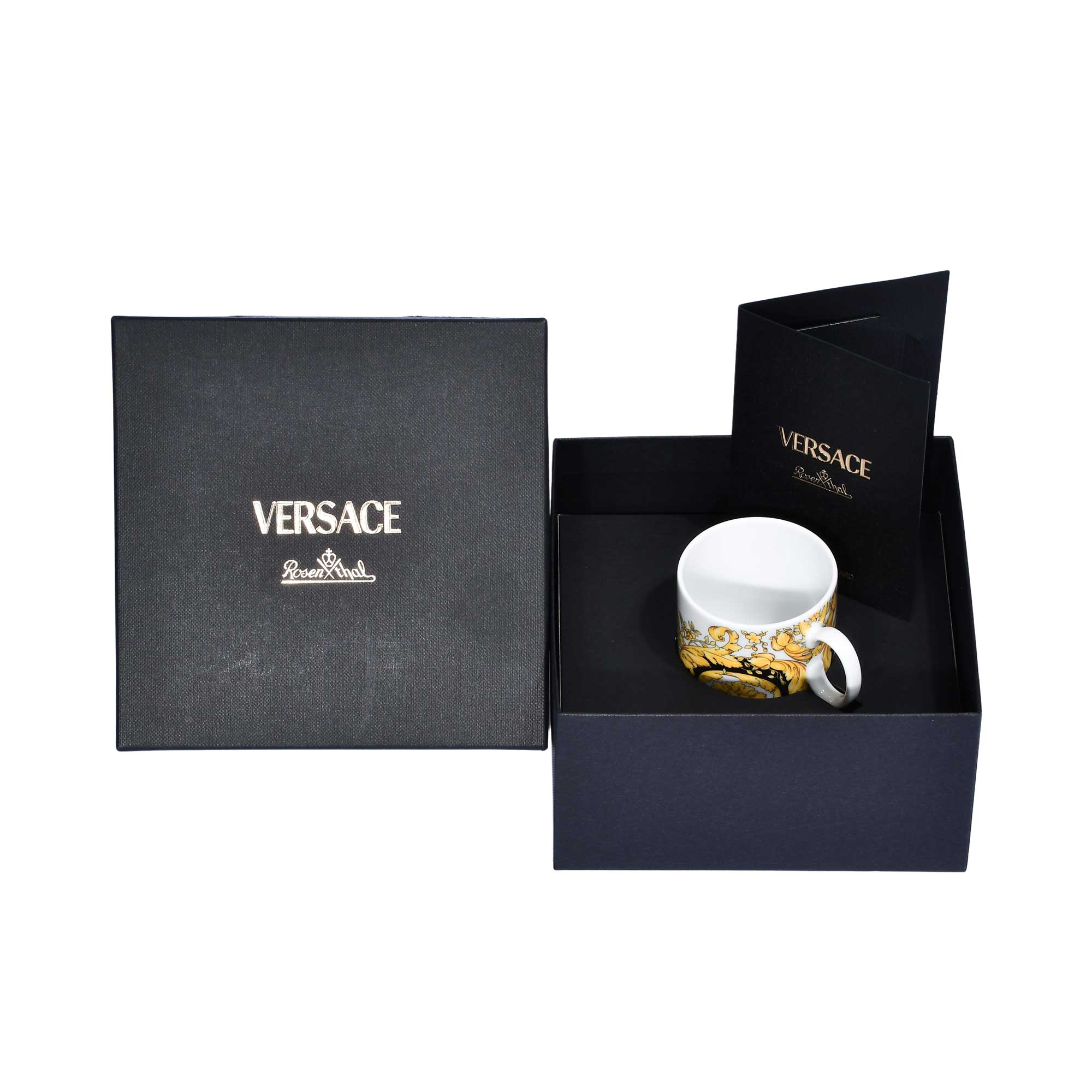 The Versace Baroque mug shown inside its black branded gift box with an accompanying authenticity brochure.