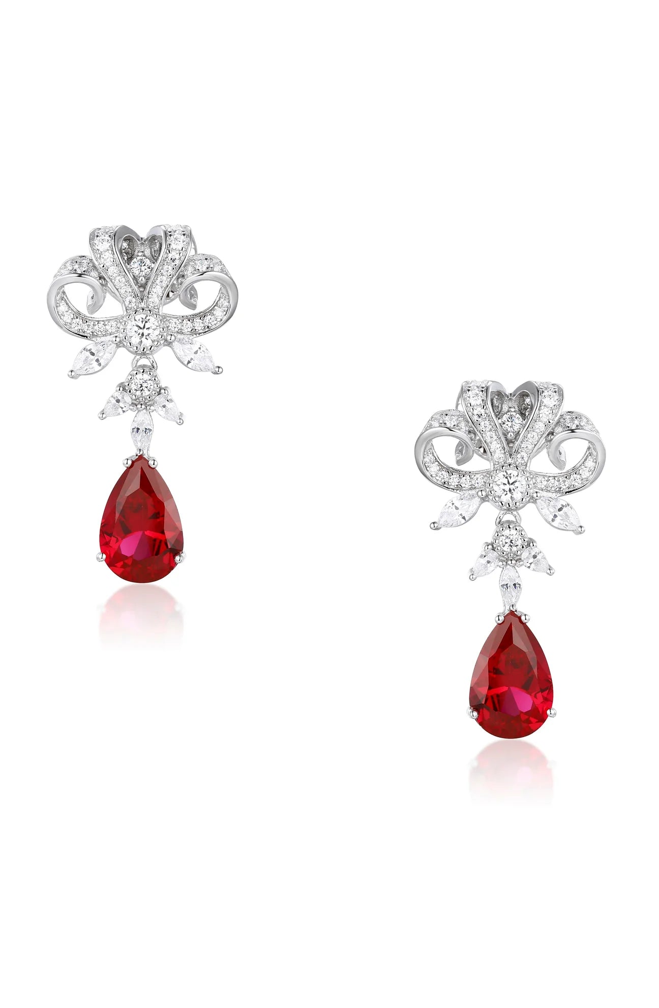 Pair of silver-toned drop earrings with a pavé-set bow design, marquise-cut clear stones, and a large faceted red crystal tea