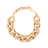 Gold-toned chunky chain bracelet with irregular links, each adorned with multiple clear, round stones, and a hook clasp.