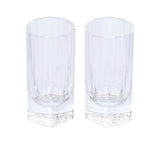 A pair of clear, modern highball glasses featuring vertical crystalline cuts and a thick hexagonal base.