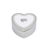 A polished silver heart-shaped trinket box featuring a white enamel lid with an embossed heart border and central silver heart motif.