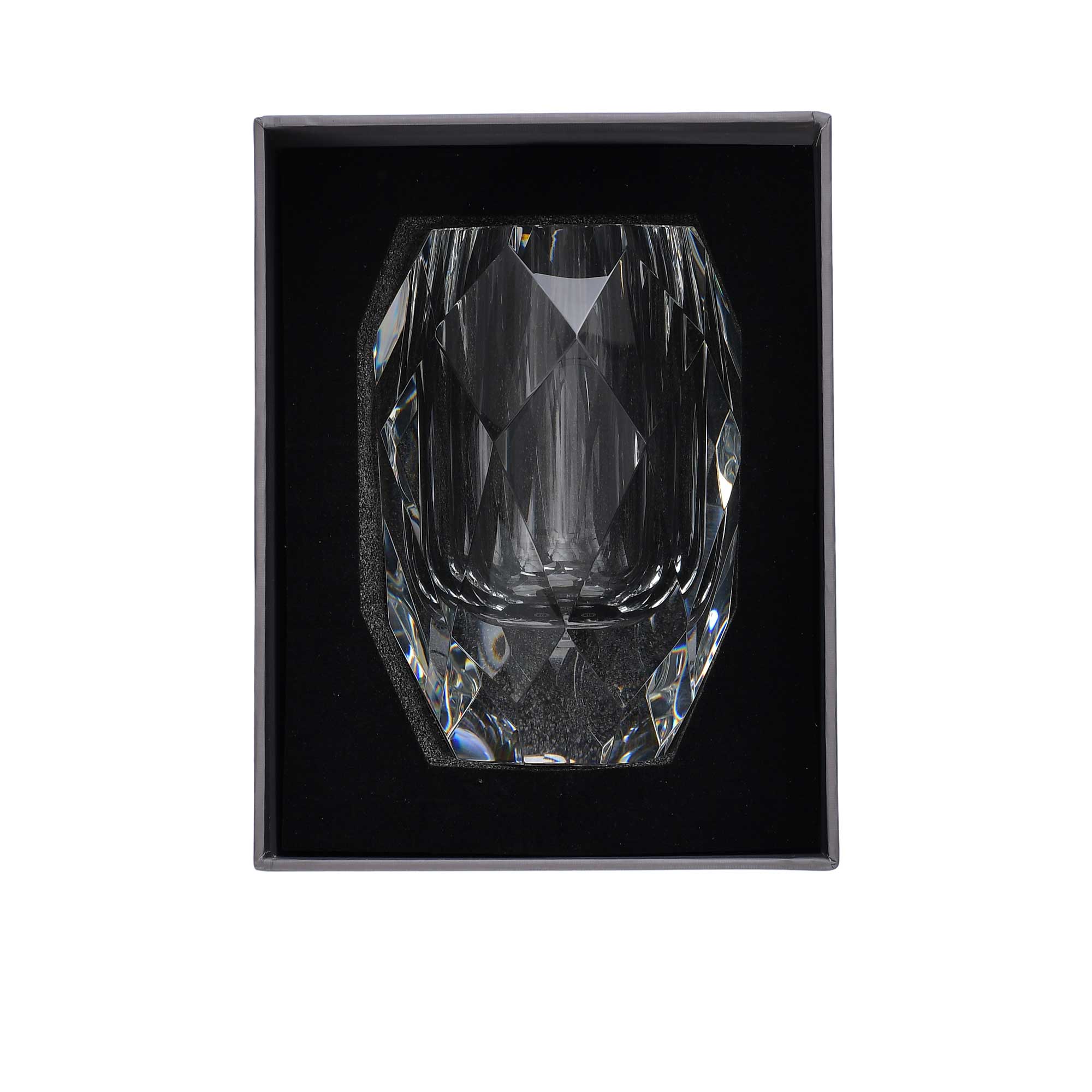 Crystal tumbler in a black box on a white background.