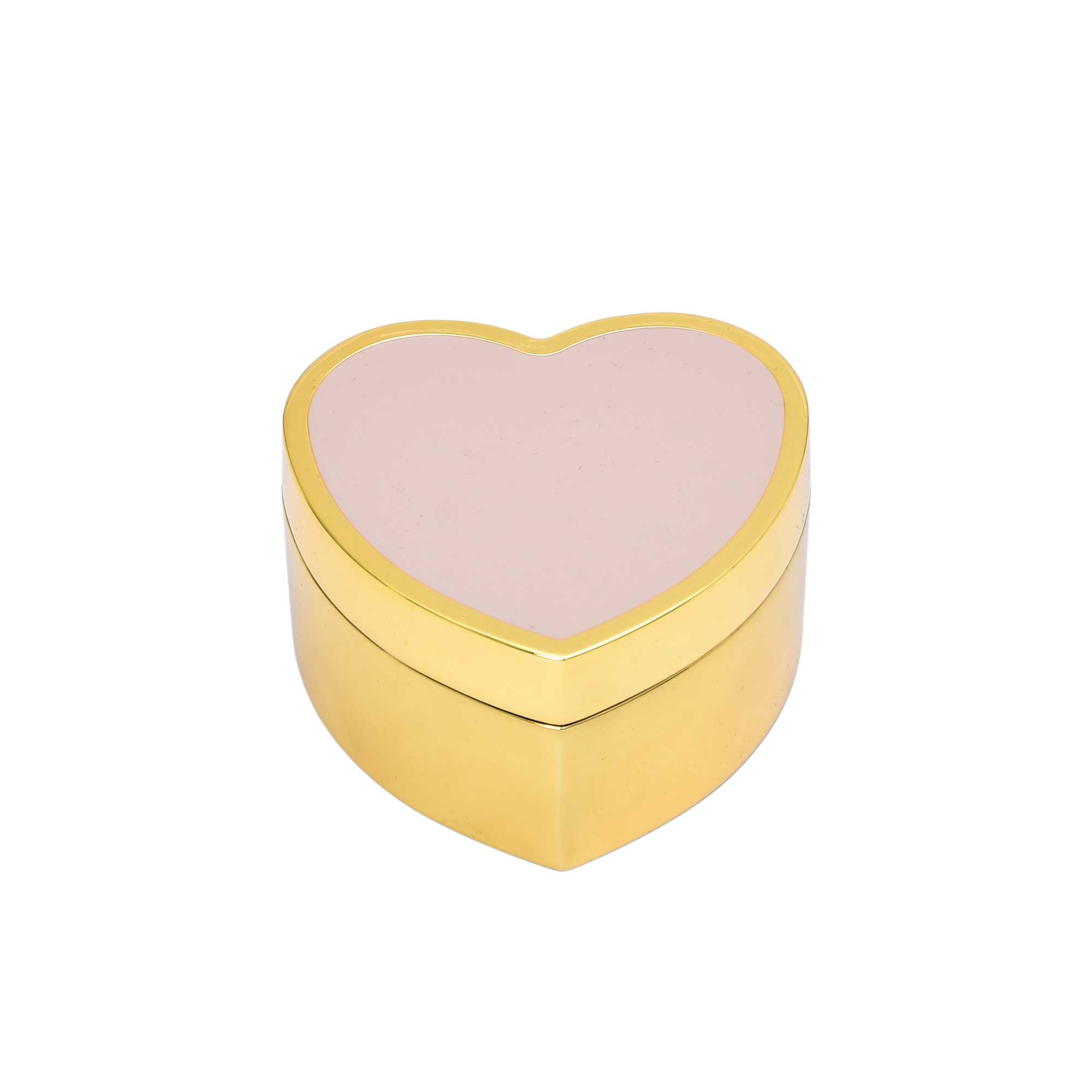 A heart-shaped gold jewelry box with a smooth blush pink enamel top on a white background.