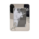 A front-facing view of a polished silver rectangular photo frame featuring a decorative embossed giraffe in the bottom left corner.