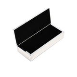 The silver Winko box opened to show the contrast between the turquoise exterior and the dark black velvet-lined interior.