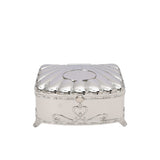 A decorative silver jewelry box featuring a scalloped shell-style lid and heart-shaped engravings on elegant curved feet.