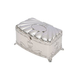 Silver jewelry box with decorative elements on a white background.