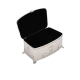 Decorative jewelry box with open lid on a white background.