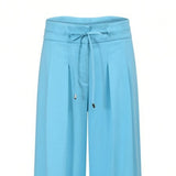 Close-up shot highlighting the detailed drawstring waistband, metallic hardware, and front pleating on the sky blue trousers at BLUE SALON shop.