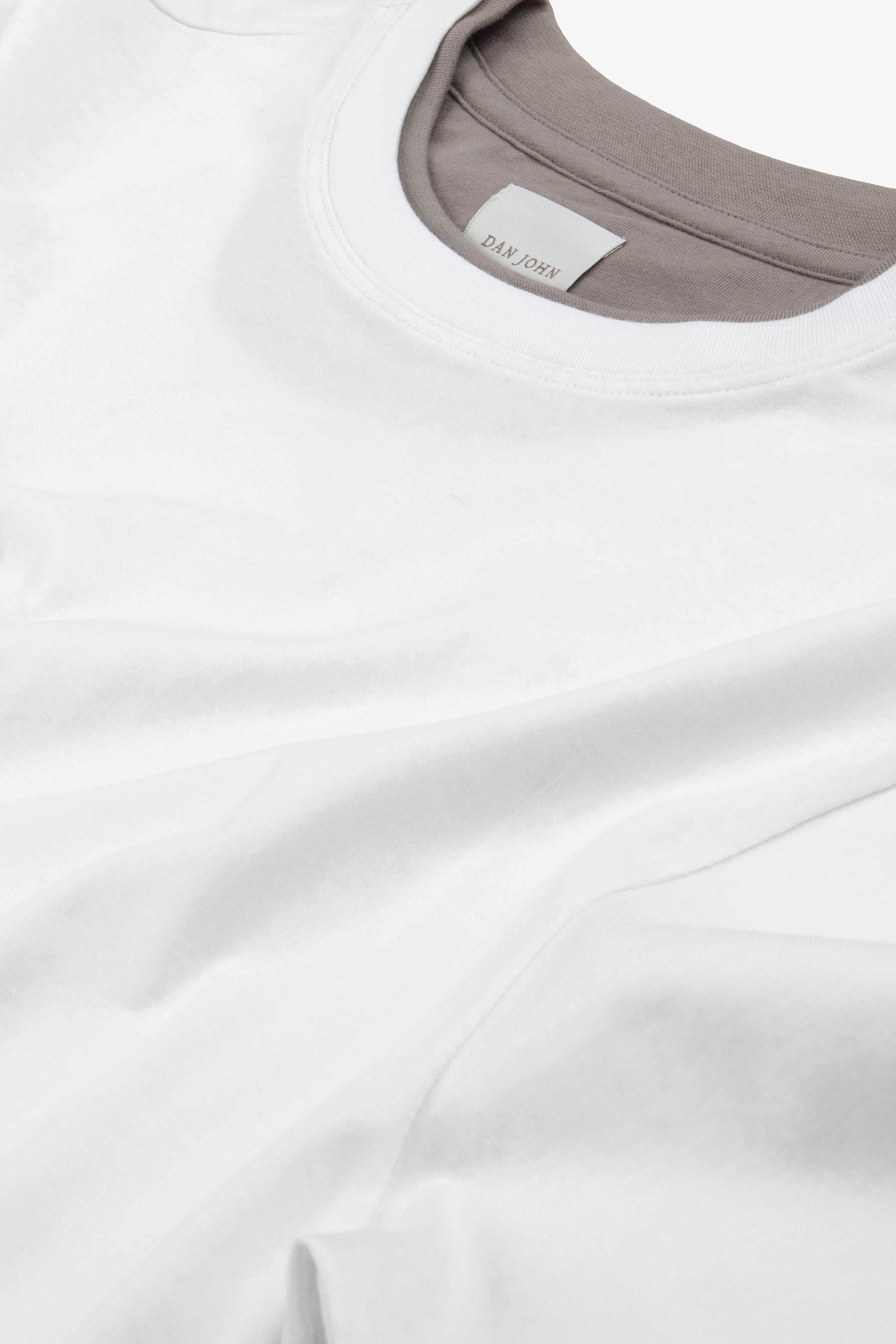 Panna (off-white) short-sleeve t-shirt with a ribbed crew neck. Soft fabric, 'DAN JOHN' label visible inside neck.