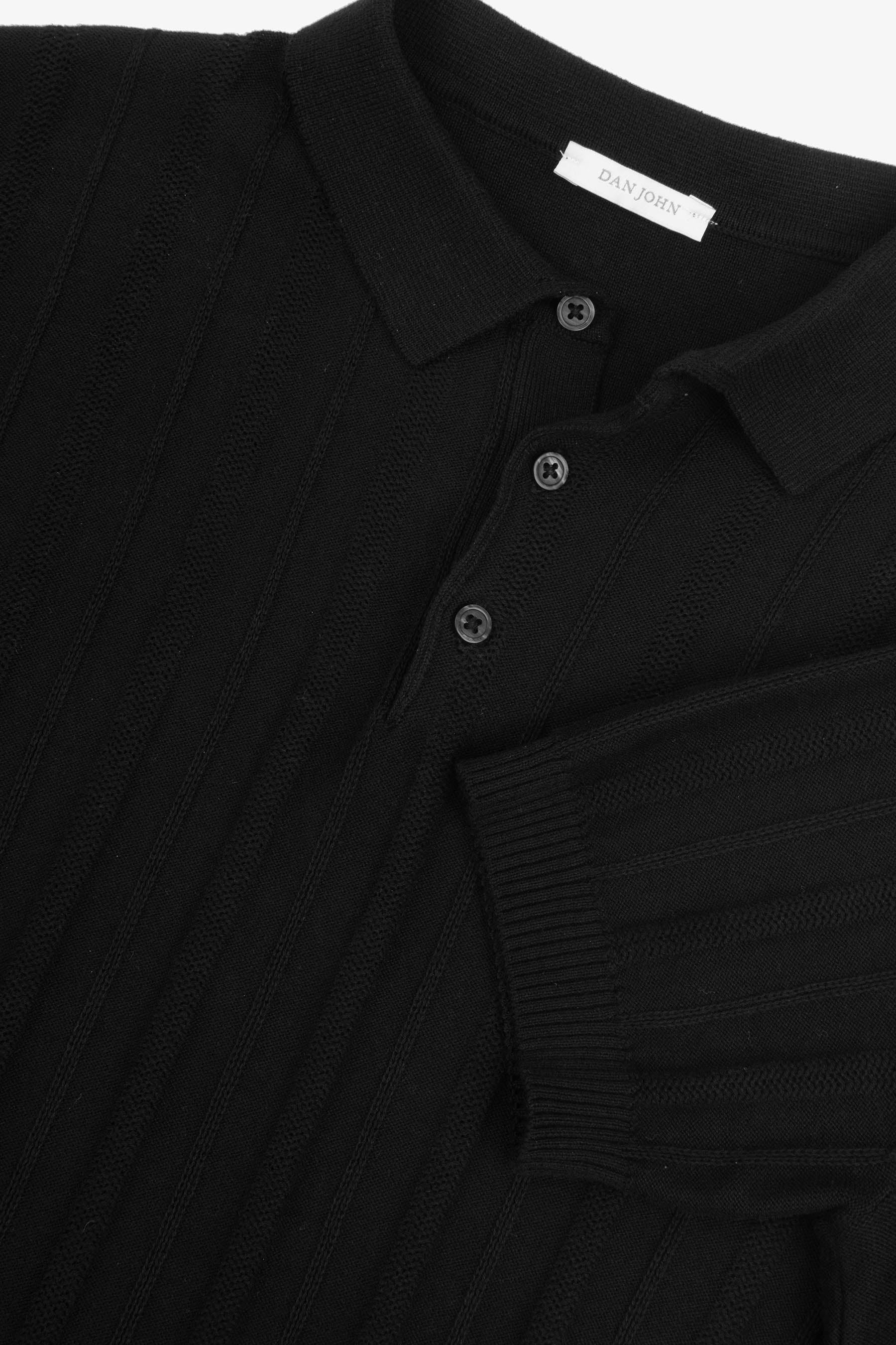 Black knit polo shirt with vertical textured stripes, ribbed collar, three-button placket, and ribbed short sleeves.