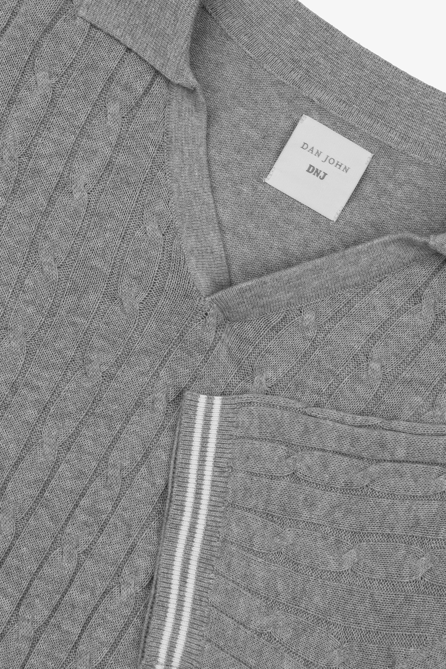 Grey cable knit short-sleeve polo shirt with a ribbed collar and a sleeve cuff featuring two white stripes.