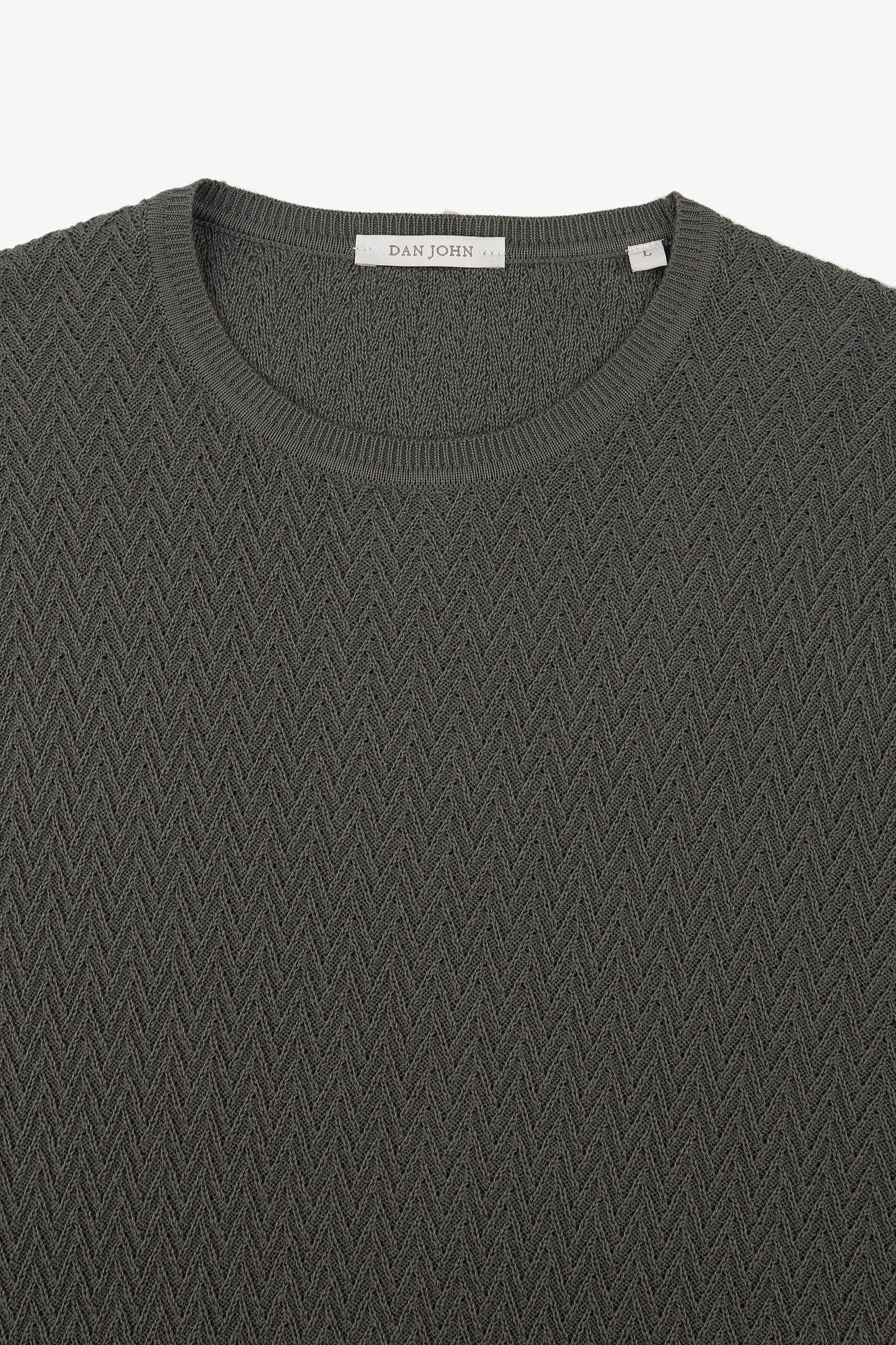Dark grey knit t-shirt with a ribbed crew neck and an all-over chevron pattern.