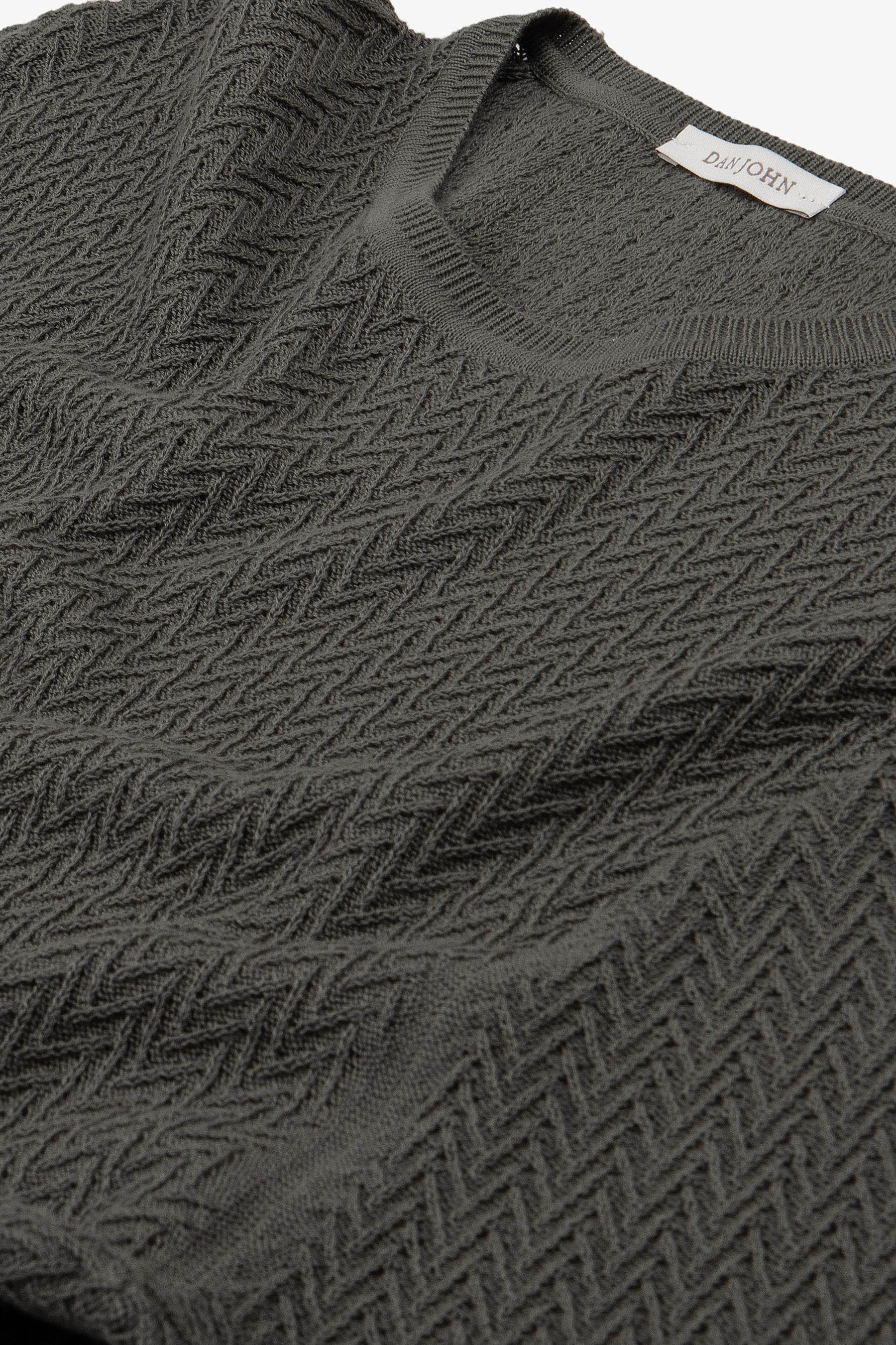 Dark grey knit short sleeve V-neck T-shirt with an all-over chevron pattern and ribbed collar.