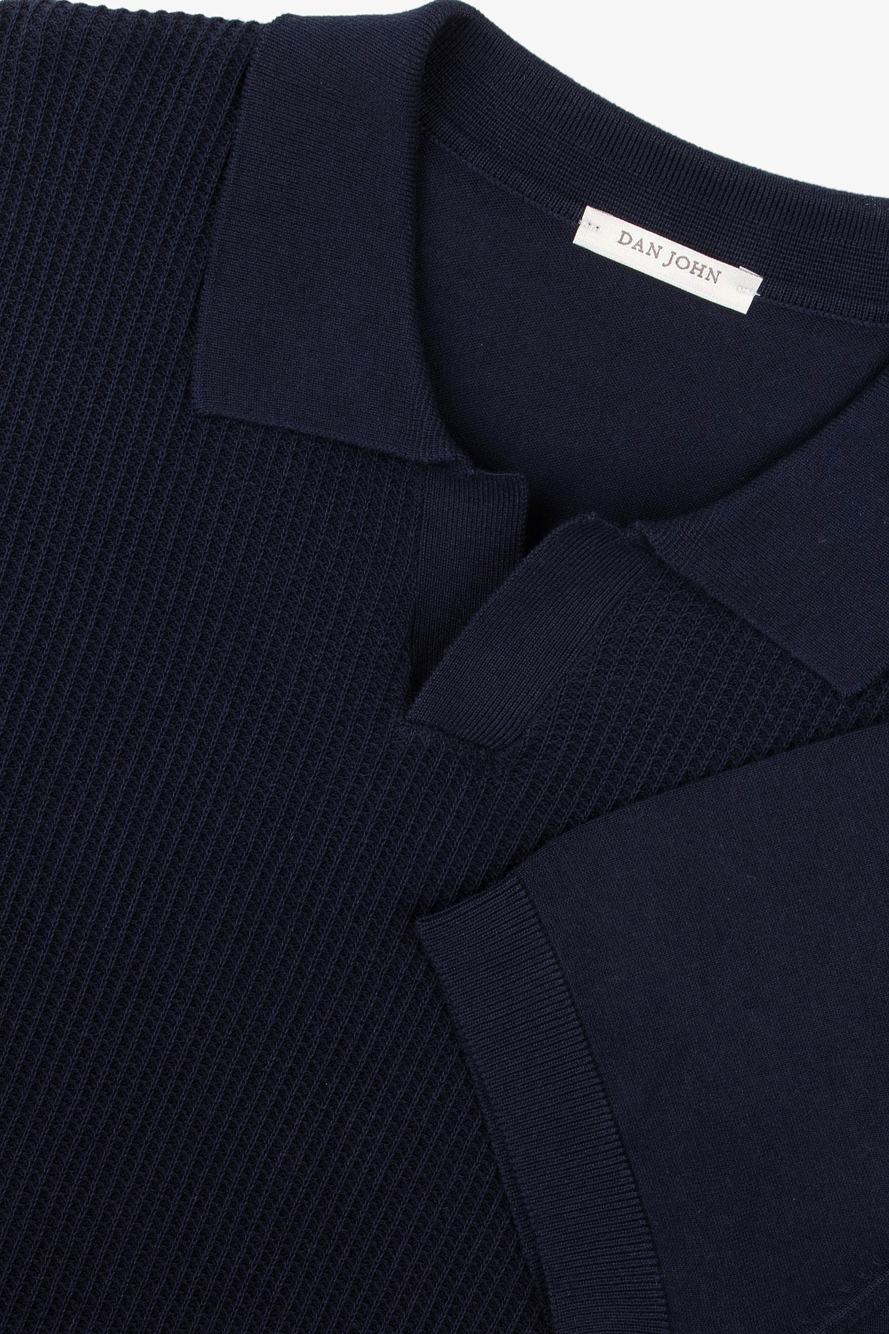 Navy short-sleeved knit polo shirt with a waffle-knit body, classic collar, V-neck placket, and ribbed sleeve cuffs.