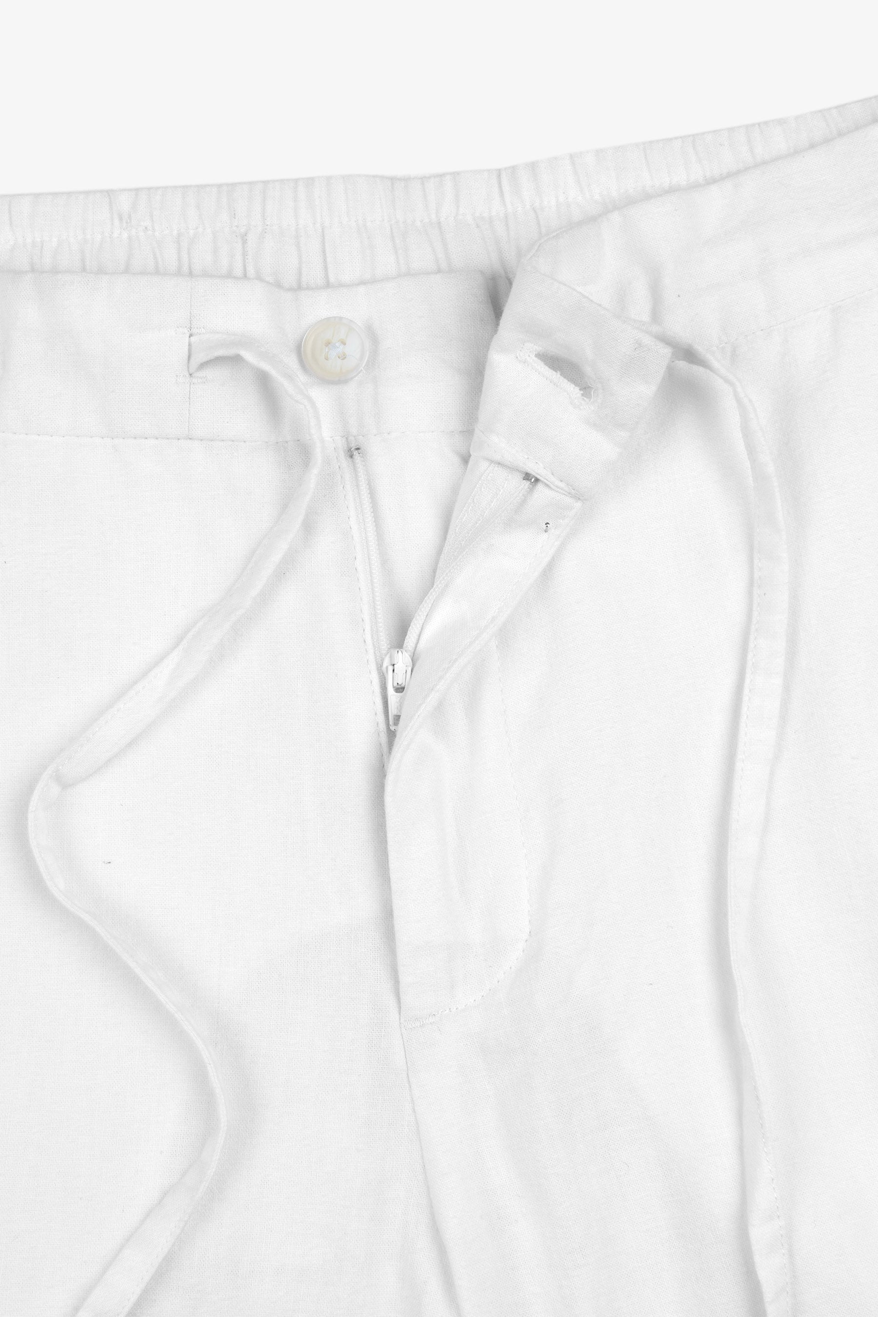 White linen blend trousers with an elasticated drawstring waist, featuring a partially unzipped fly with a white button and b