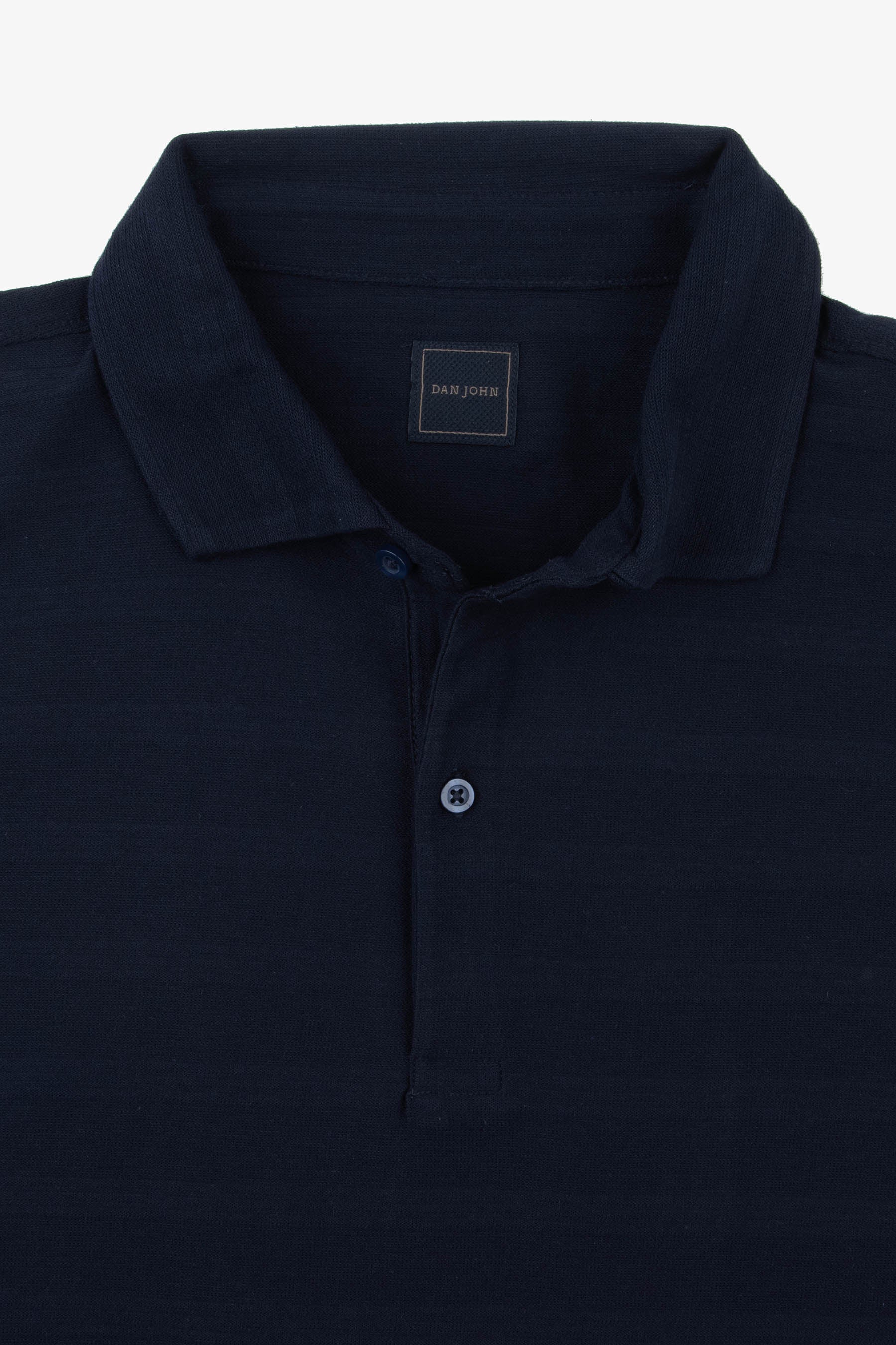 Navy blue knit polo shirt with a ribbed collar and a two-button placket. Light blue buttons with cross stitching.
