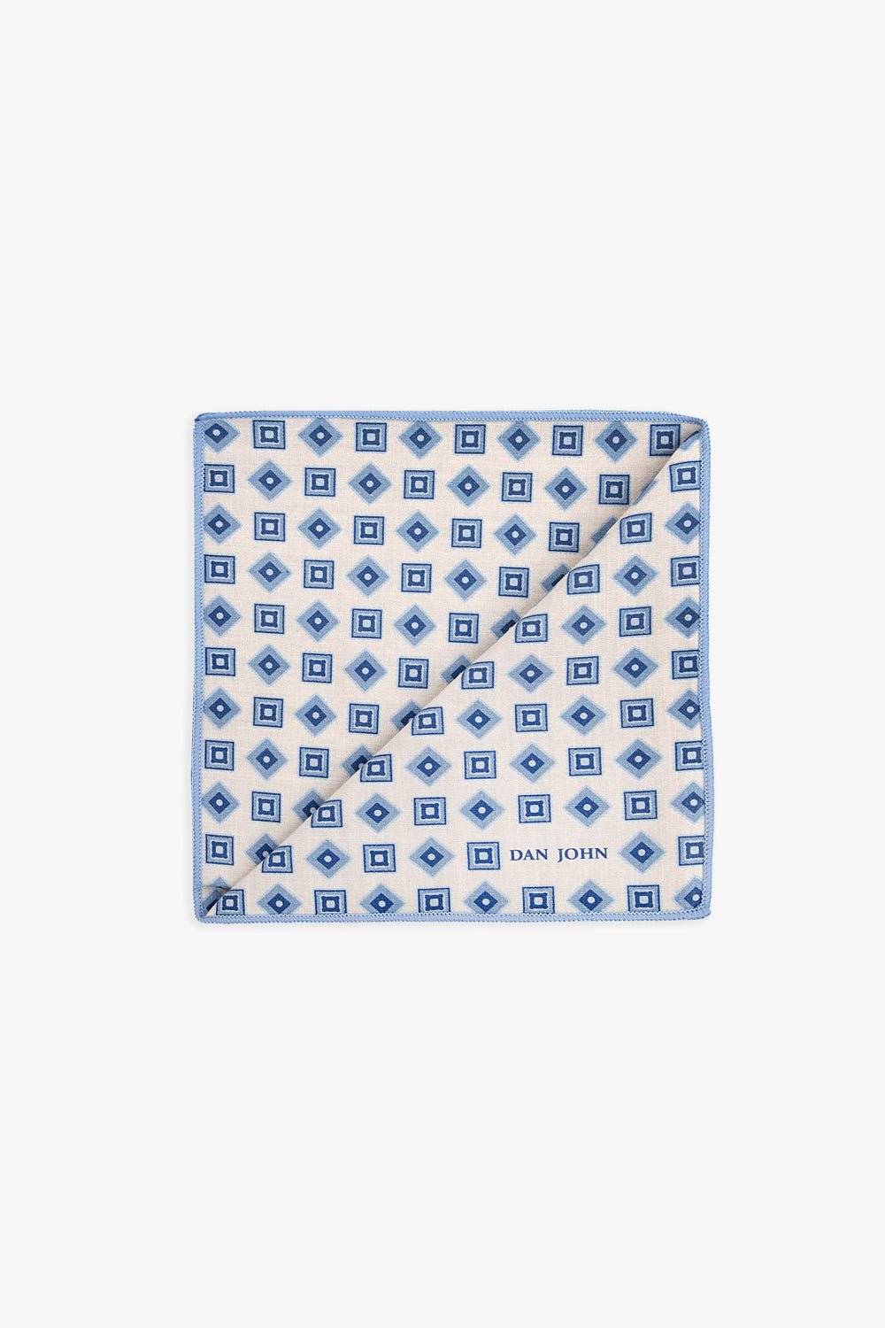 Cream handkerchief with a repeating pattern of light blue squares and dark blue diamonds, light blue stitched border, and 'DA