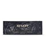 A long, elegant black presentation box for the Xerjoff Trittico Nero candle set, featuring a silver-grey marbleized swirl pattern and gold-stamped branding for the three included scents.