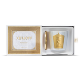 A close-up of the Dark Violette scented candle in a tapered purple glass holder, featuring an intricate gold star-patterned label and the embossed Xerjoff "X" logo.
