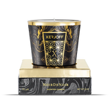 The luxury packaging for the Xerjoff Noir De Noir candle, showcasing a dark grey and white marble-patterned box with a prominent gold "X" logo and gold-stamped product name.