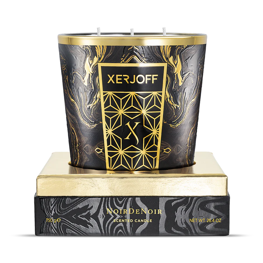 The 750g Noir De Noir scented candle showcased in its open, felt-lined presentation box, highlighting the large-scale black glass holder with its intricate gold star-patterned label.