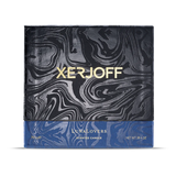The luxury packaging for the Xerjoff LunaLovers candle, showing a black and grey marbled lid with gold "XERJOFF" branding and a textured blue base.