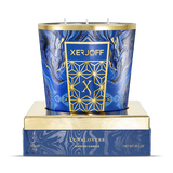A large Xerjoff LunaLovers scented candle with three wicks, featuring a vibrant blue and black marbled pattern and gold trim, displayed on its gold and blue presentation base.