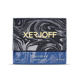 Luxury packaging for the TrueBlue candle, showing a black and grey marbled lid with gold branding above a textured blue base.