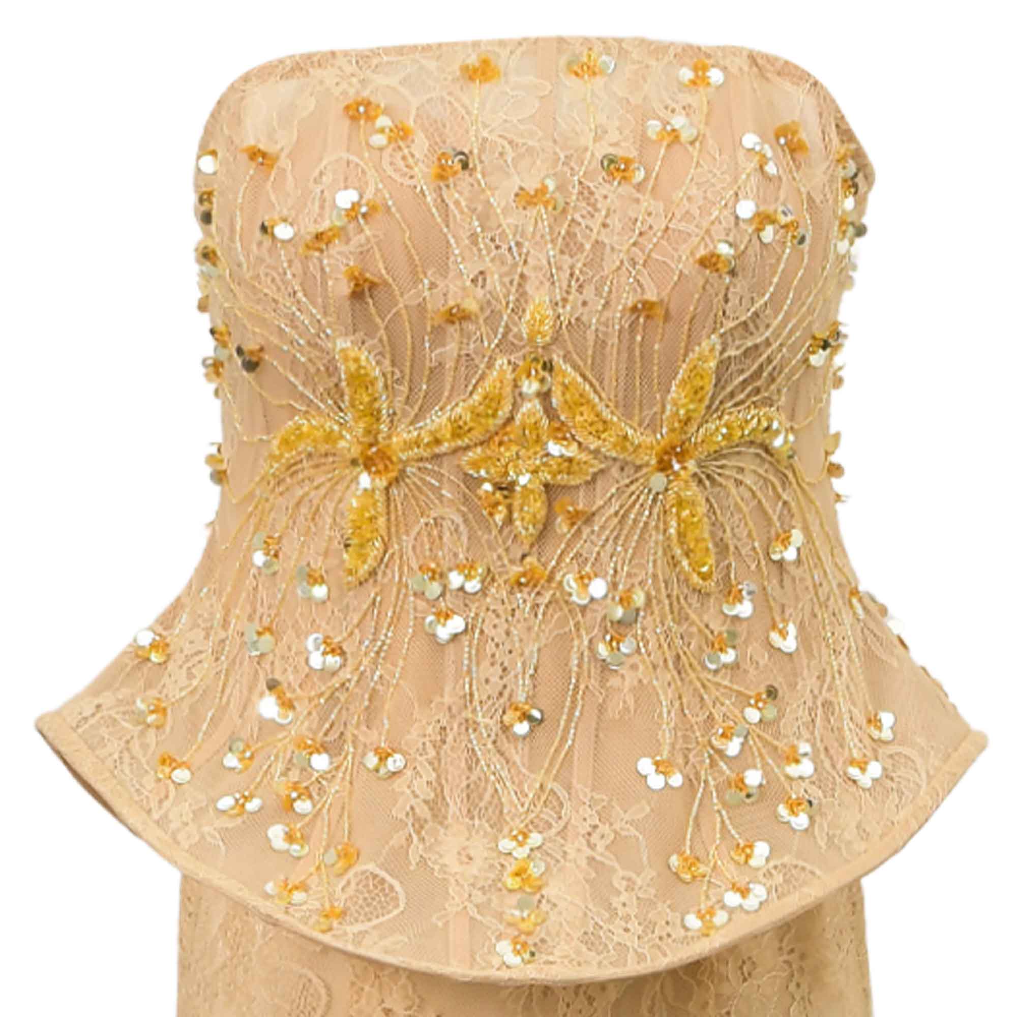Beige strapless peplum dress bodice with lace, gold-toned floral embroidery, gold-toned beads, and silver-toned sequins.