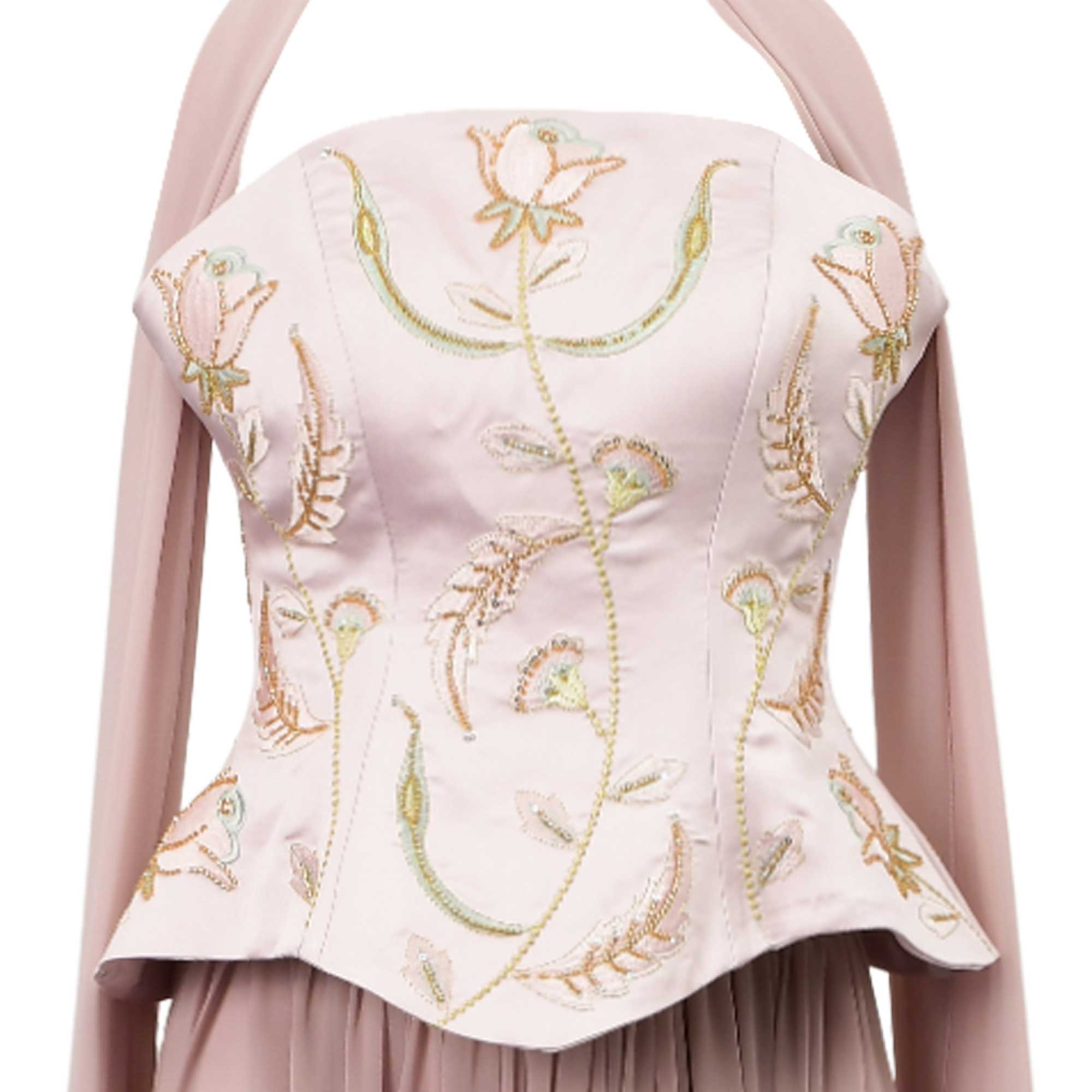 Pale mauve strapless dress with a peplum bodice, featuring pink, green, and gold-toned floral embroidery and long flowing str