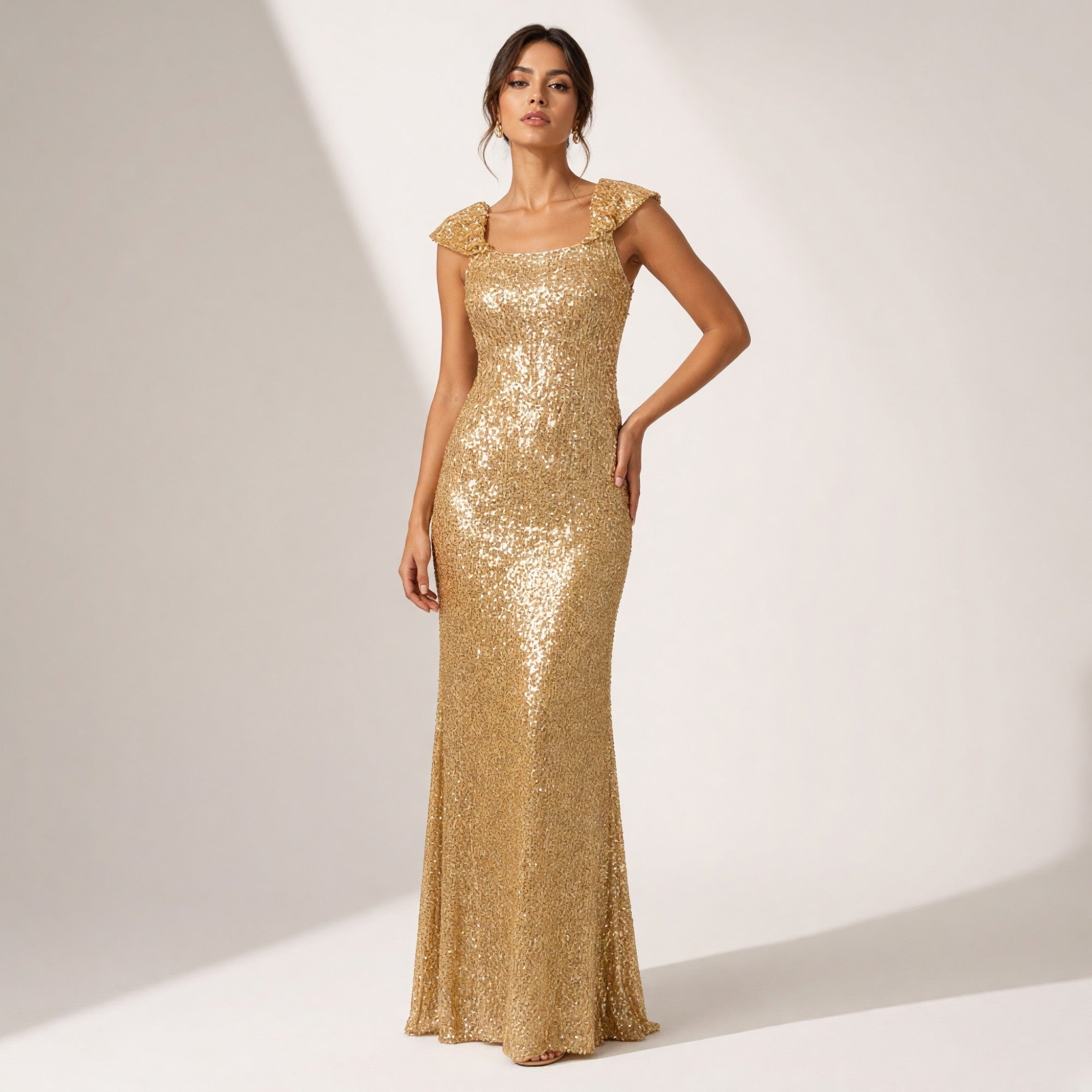 Gold-toned sequined maxi dress with a square neckline, short ruffled cap sleeves, and a fitted silhouette.