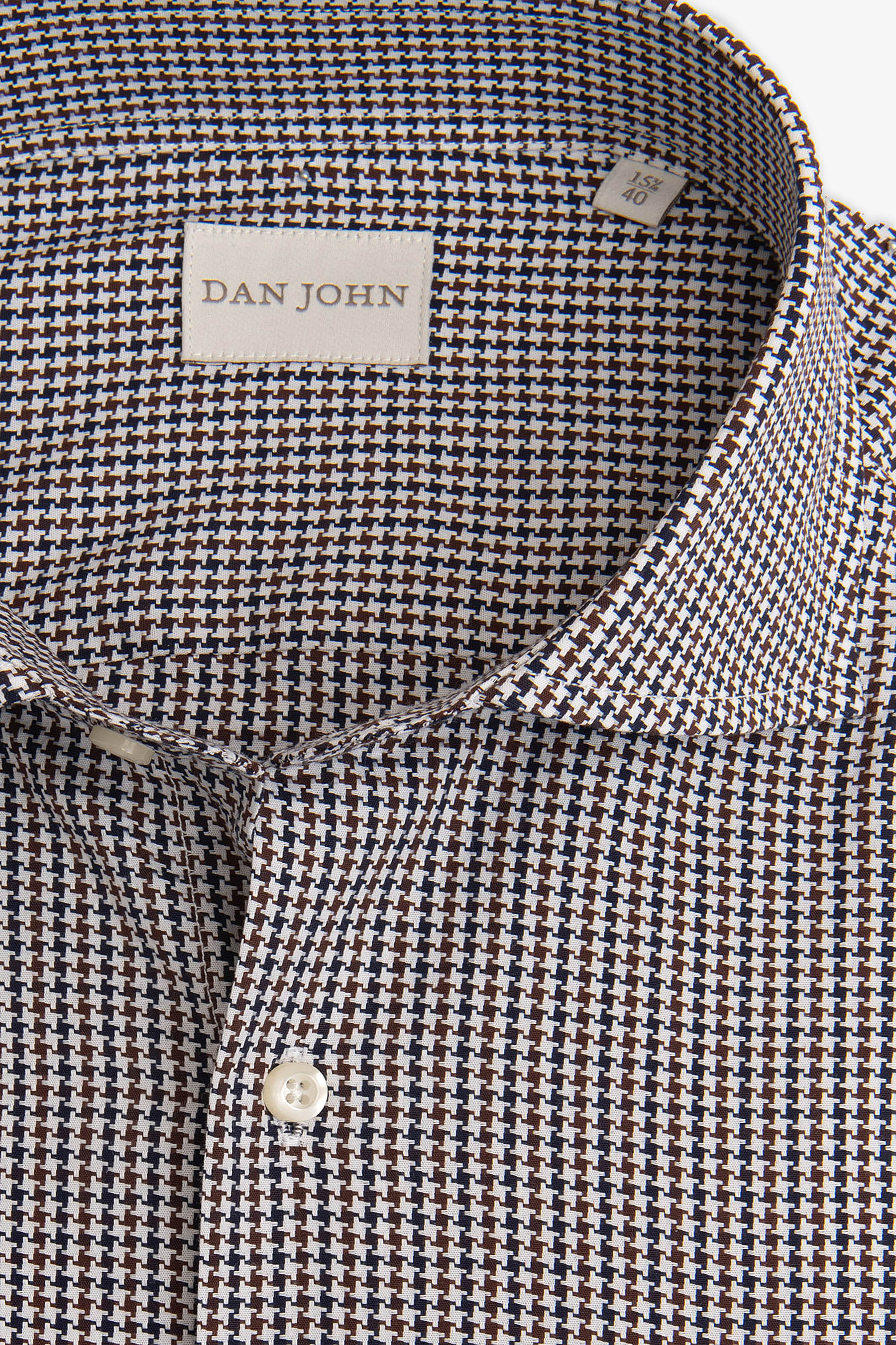 Men's dress shirt in a white, brown, and navy small houndstooth pattern, featuring a classic collar and white buttons.