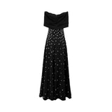 Back view of black strapless maxi dress with oversized bow neckline and white polka dot detailing.
Back view of black strapless maxi dress with fitted bodice and flowing skirt.
