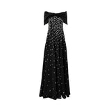 Front view of black strapless maxi dress with oversized bow neckline and white polka dot detailing.
Back view of black strapless maxi dress with fitted bodice and flowing skirt.