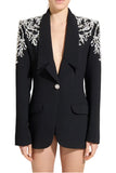 Model wearing Zuhair Murad black single-breasted blazer with crystal and pearl shoulder embellishment available at BLUE SALON.