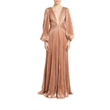A floor-length champagne rose gold pleated gown with a plunging V-neckline, long balloon sleeves, and a draped waist, shown on a model against a plain white background.