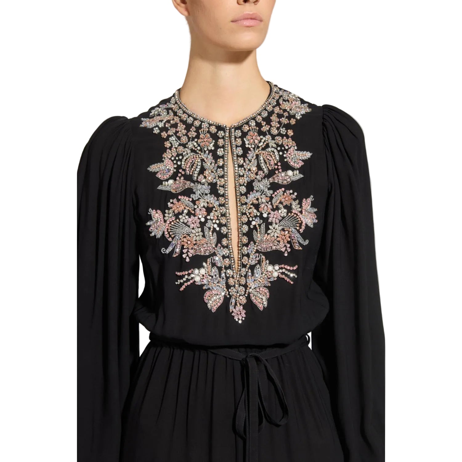 Close-up studio portrait focusing on the opulent hand-applied crystal, bead, and pink rhinestone baroque bib embroidery around the keyhole neckline of the black Zuhair Murad gown.